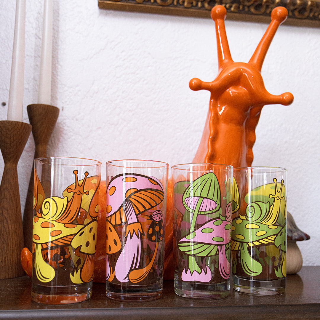 Holding a glass in front of matching orange ceramic snail
