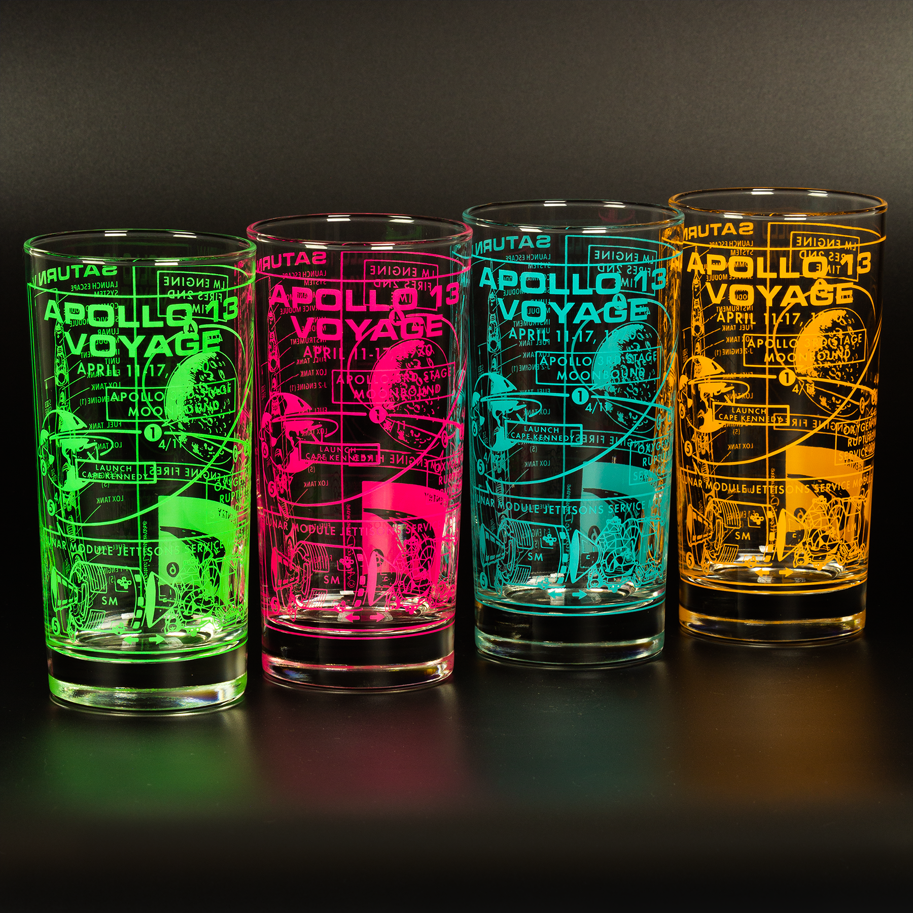 Four illuminated glasses with 'Apollo 13 Voyage' text and graphics on a dark background