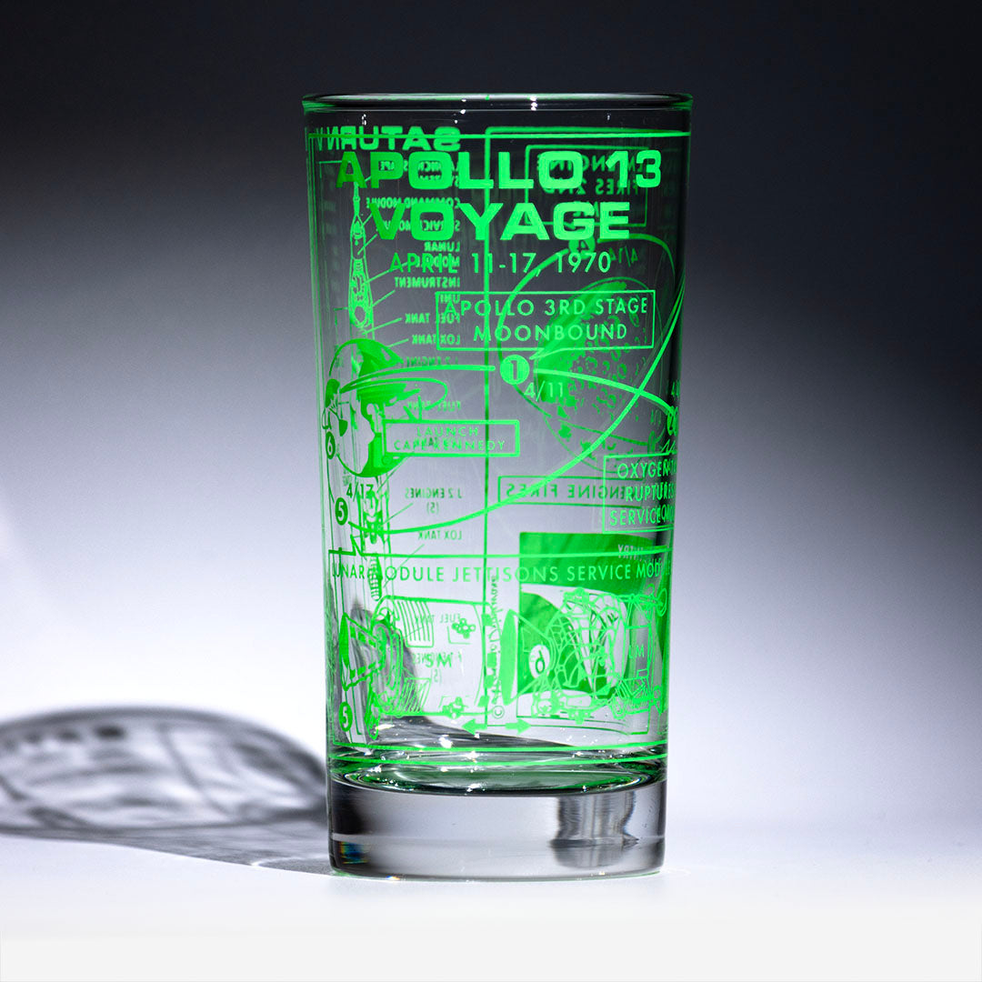 Glass with printed green space design on a dark background