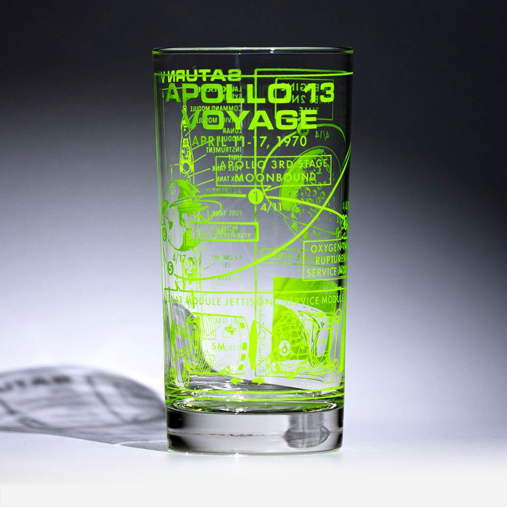 Glass with green Apollo 13 design on a gray background