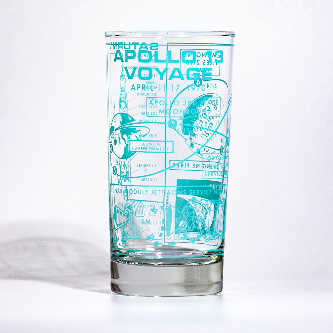 Glass tumbler with blue graphic design on a white background