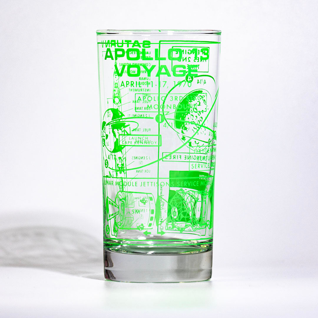 Clear glass with green Apollo Voyages design on a white background