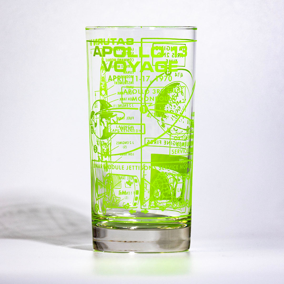 Clear glass with green astronaut-themed engraving on a white background