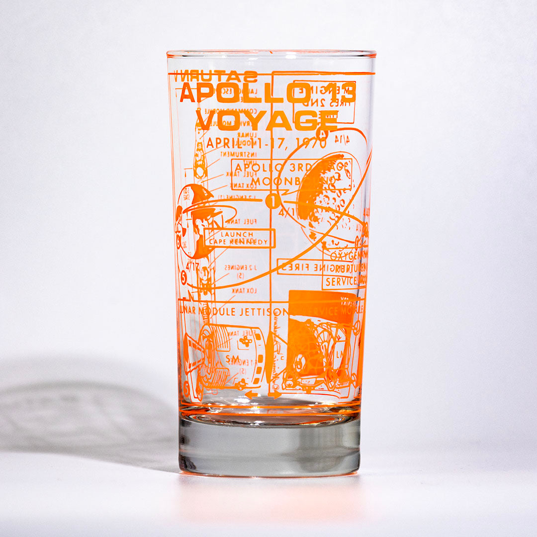 Glass with orange Apollo Voyage design on a white background