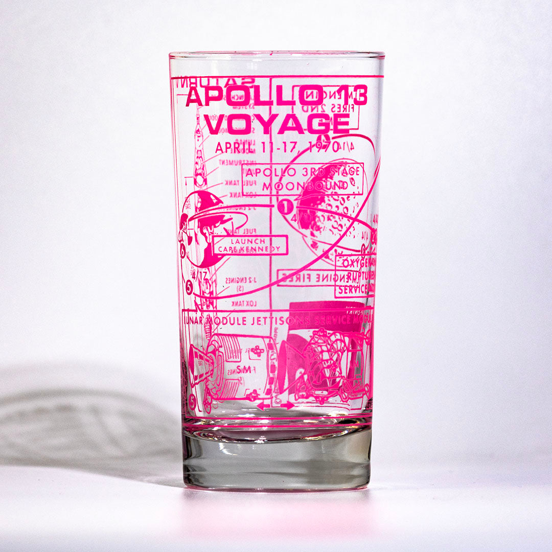 Clear glass with pink Apollo 13 Voyage design on a white background