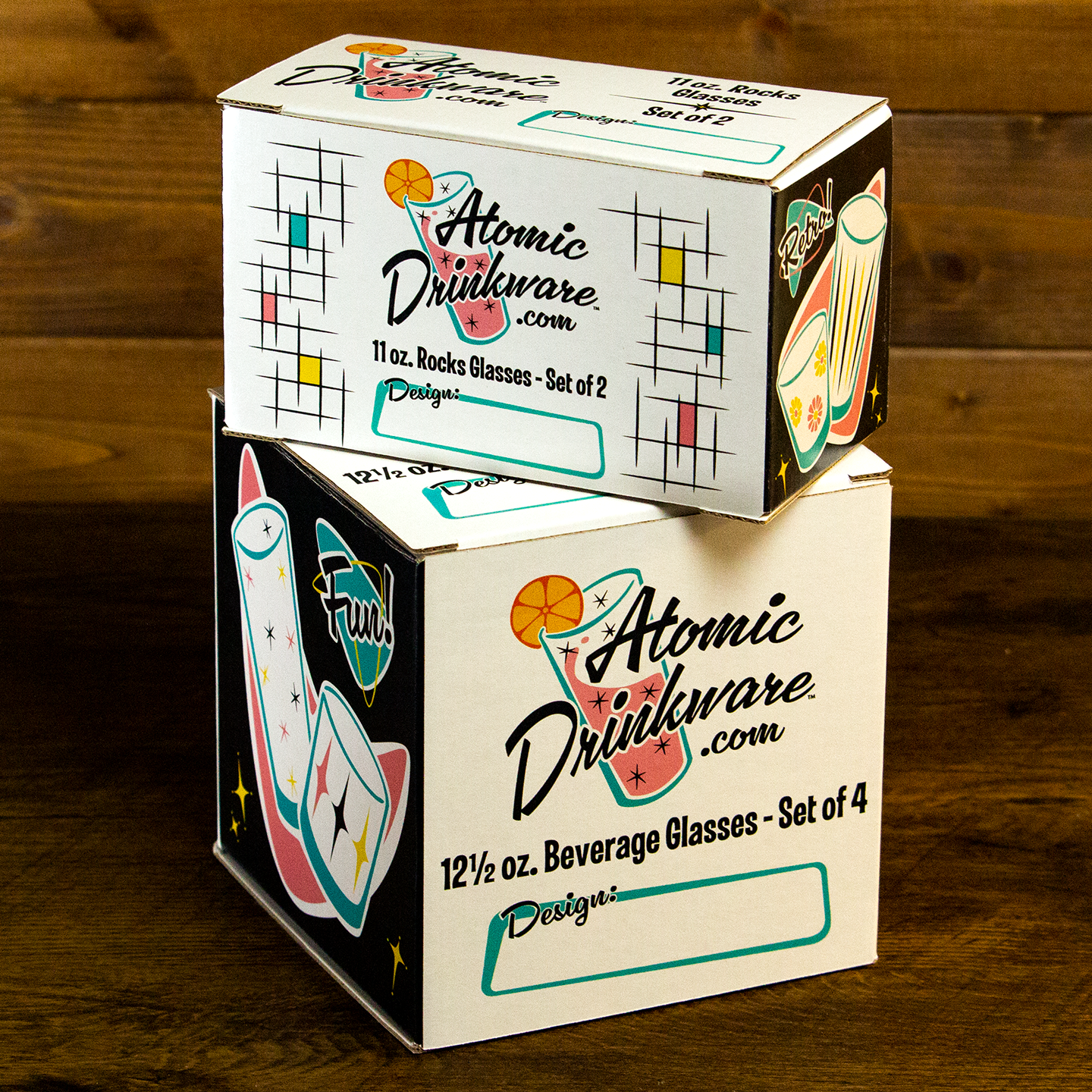 Two boxes of Atomic Drinkware on a wooden surface