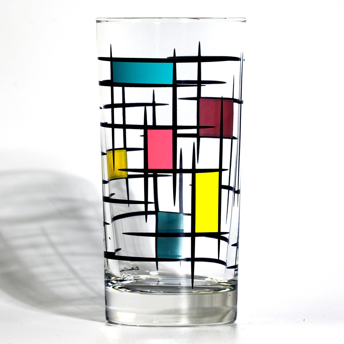 Glass with colorful brutalist 60s design for retro cocktails