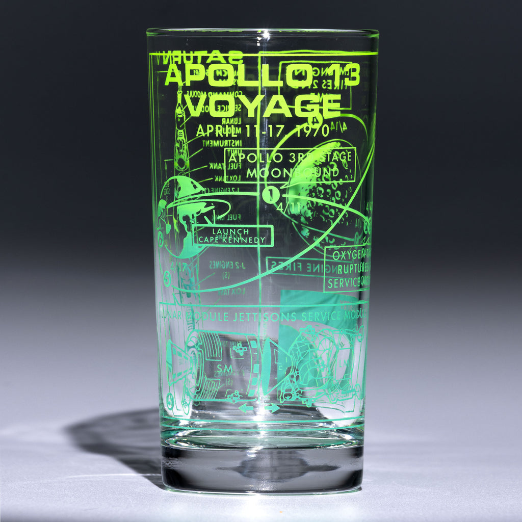 Glass with ombre Apollo 13 mission details on grey background