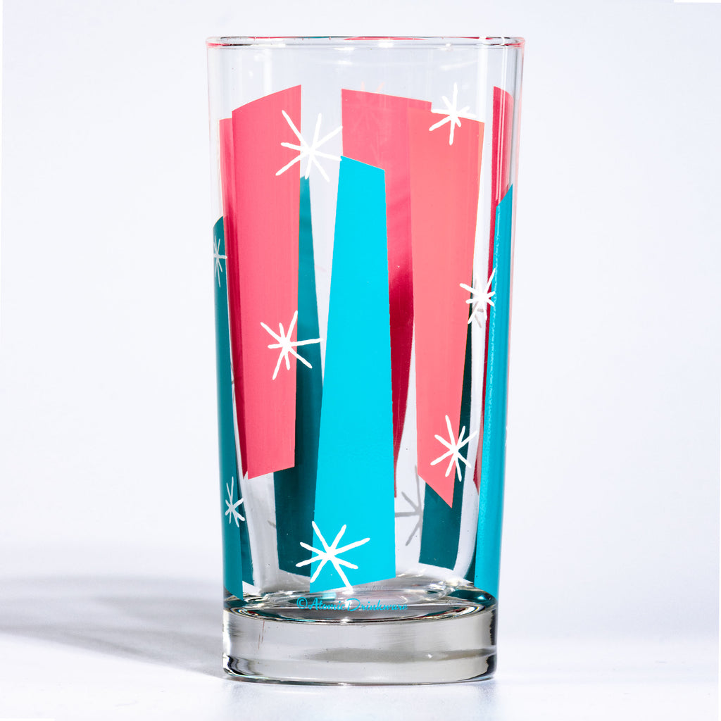 Atomic style glass with pink and blue geometric googies and white starbursts design on a white background