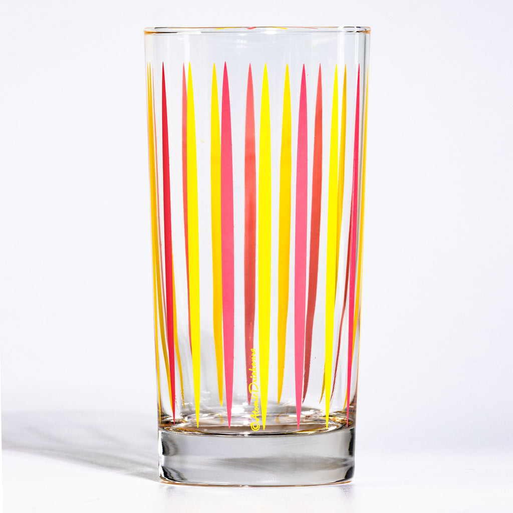 Clear mid century glass with red and yellow vertical stripes on a white background
