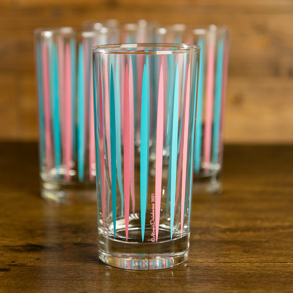 retro atomic drinkware glass tumblers for home bar with pink and blue striped design on a wooden surface