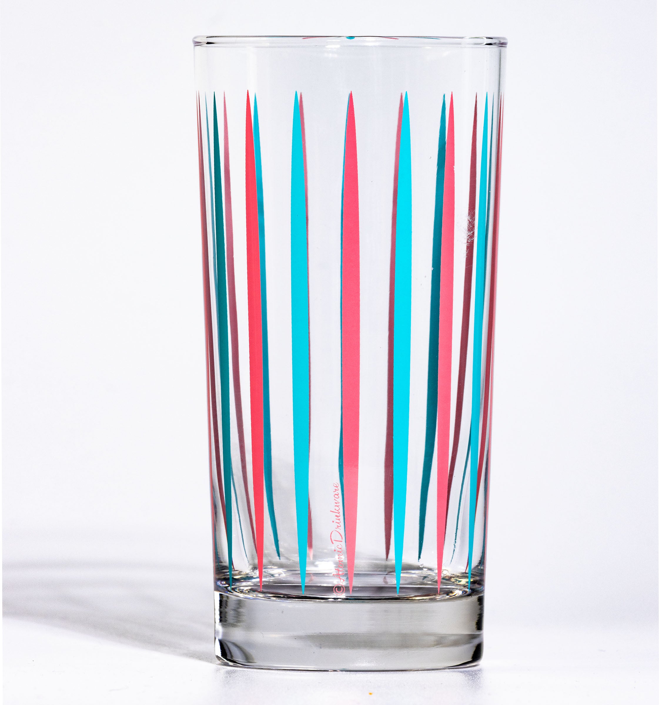 Clear glass with red and blue striped pattern on a white background