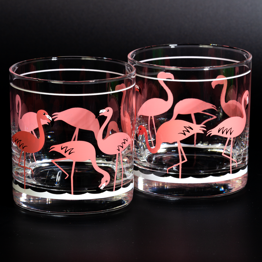 Clear glass tumblers with retro pink flamingo design on a white background