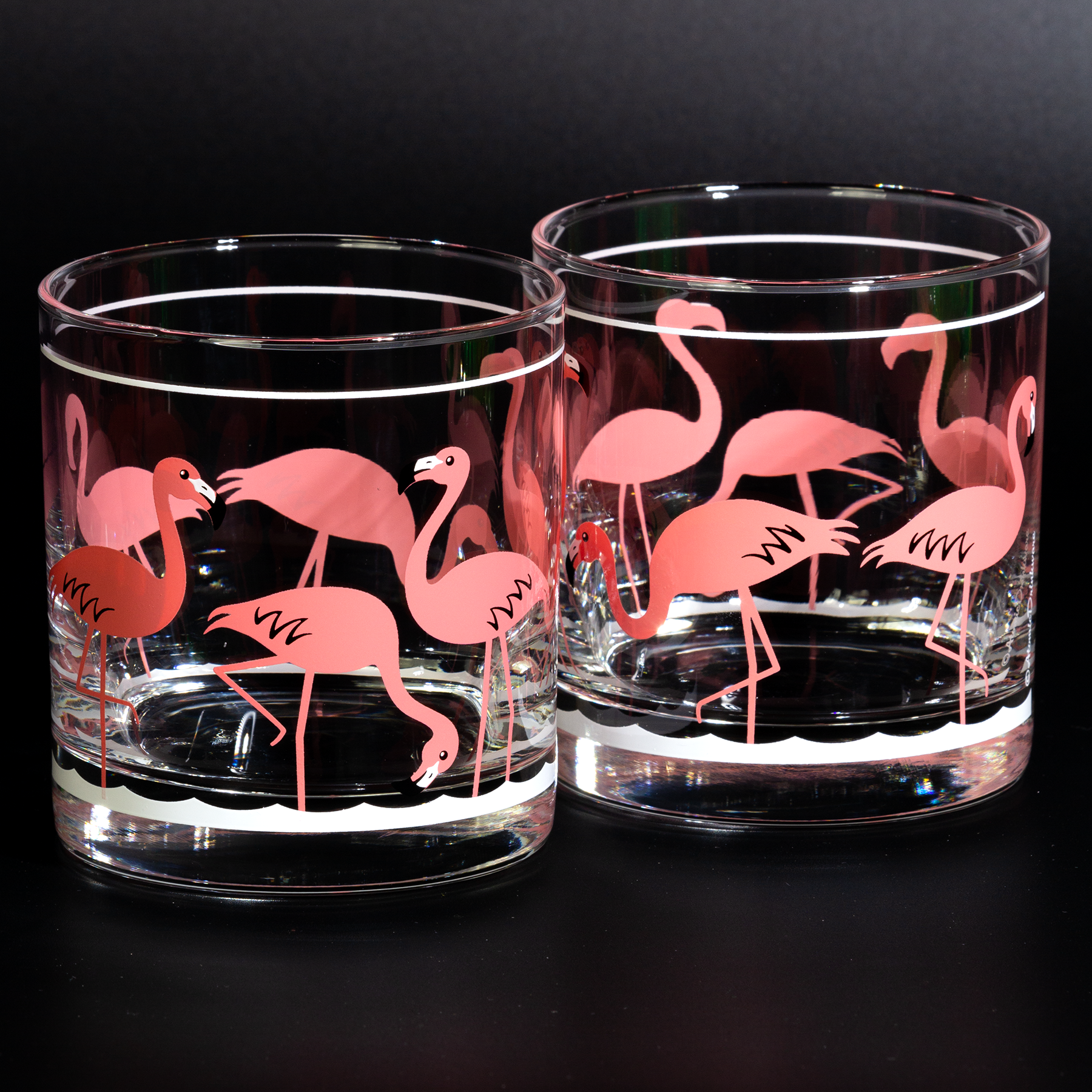 Clear glass tumblers with retro pink flamingo design on a white background