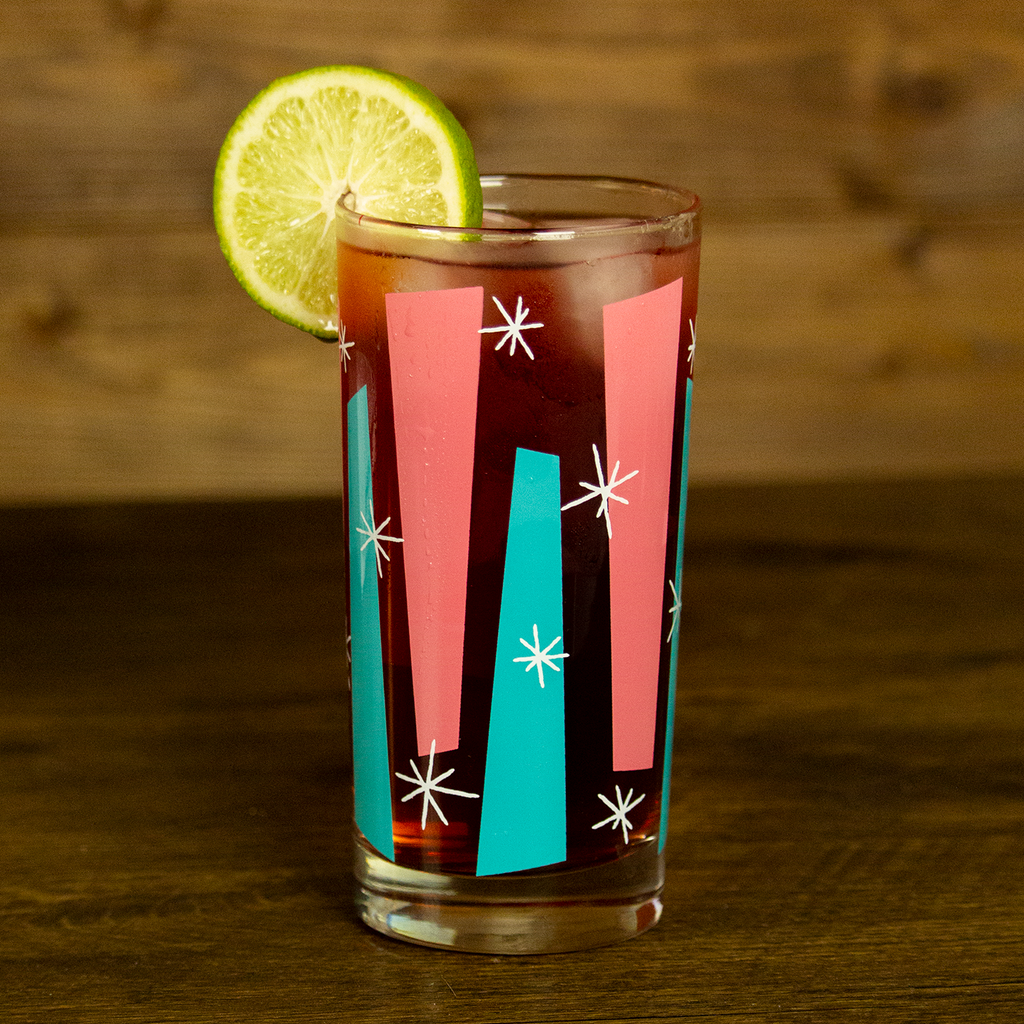 Mid century modern glassware with colorful retro design and lime wedge for home bar and entertaining