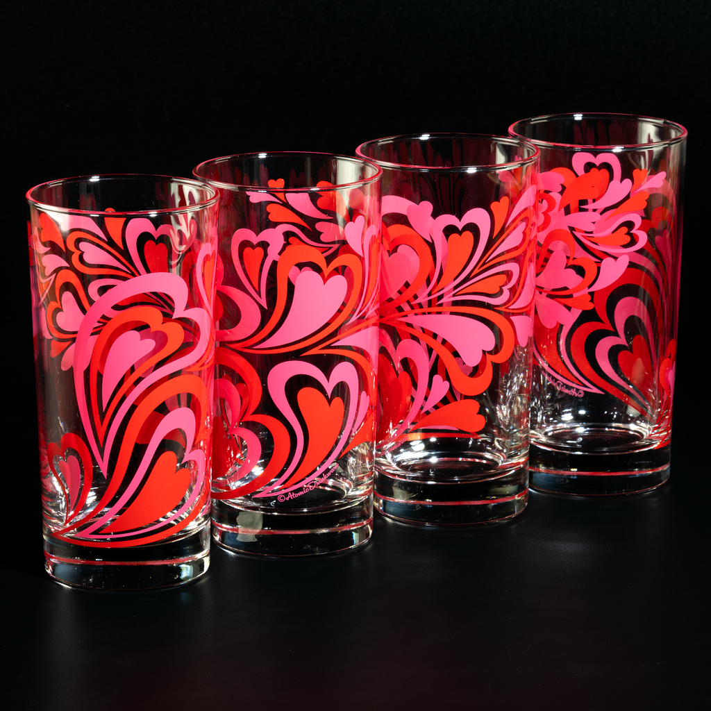 Glass tumblers with pink and red retro heart pattern on a white background