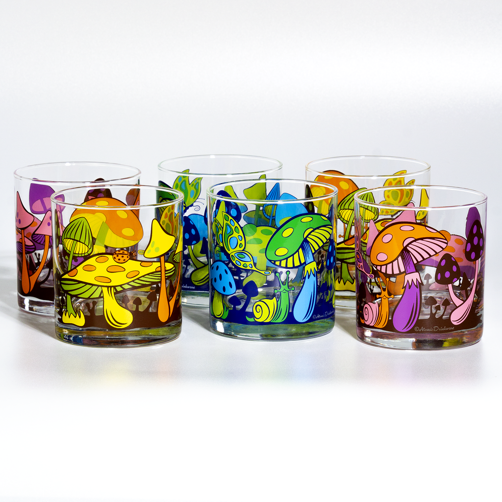 6 glass rocks glasses with 3 different colorways of the Magical Mushroom design on a white background