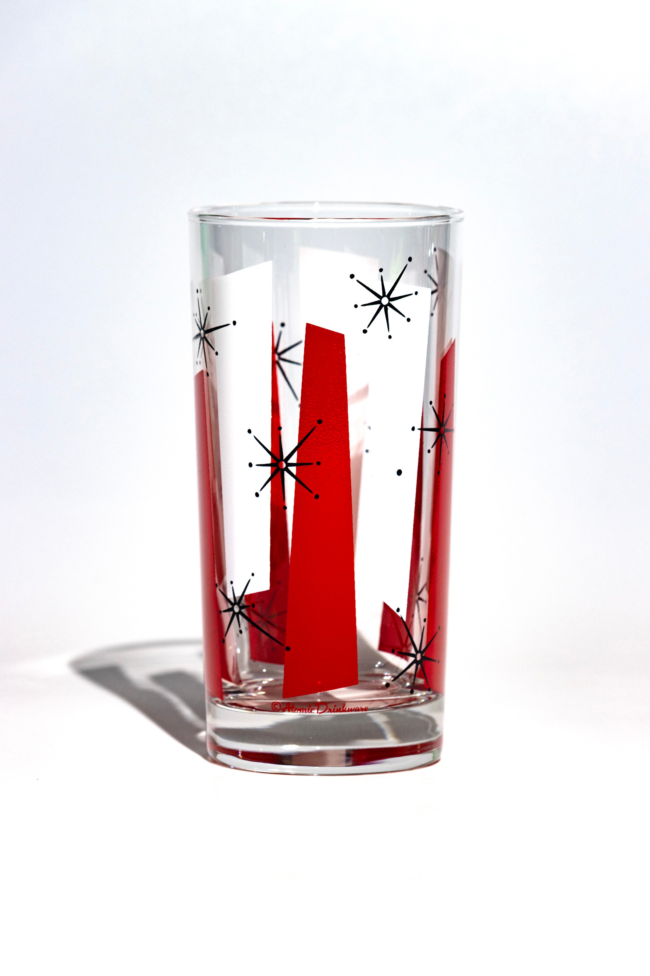 Clear glass with red and black abstract vintage design on a white background