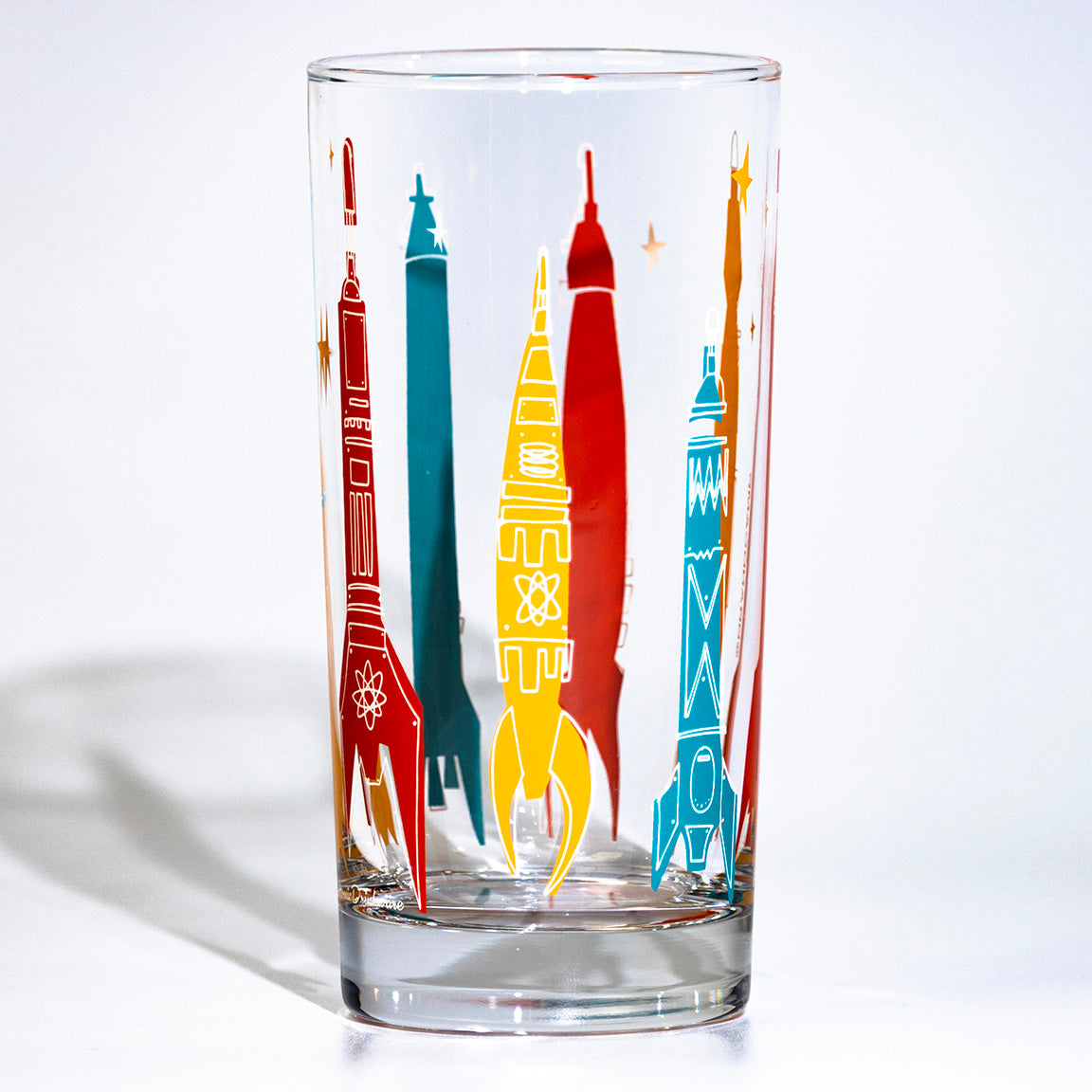 Clear glass with colorful rocket illustrations on a white background