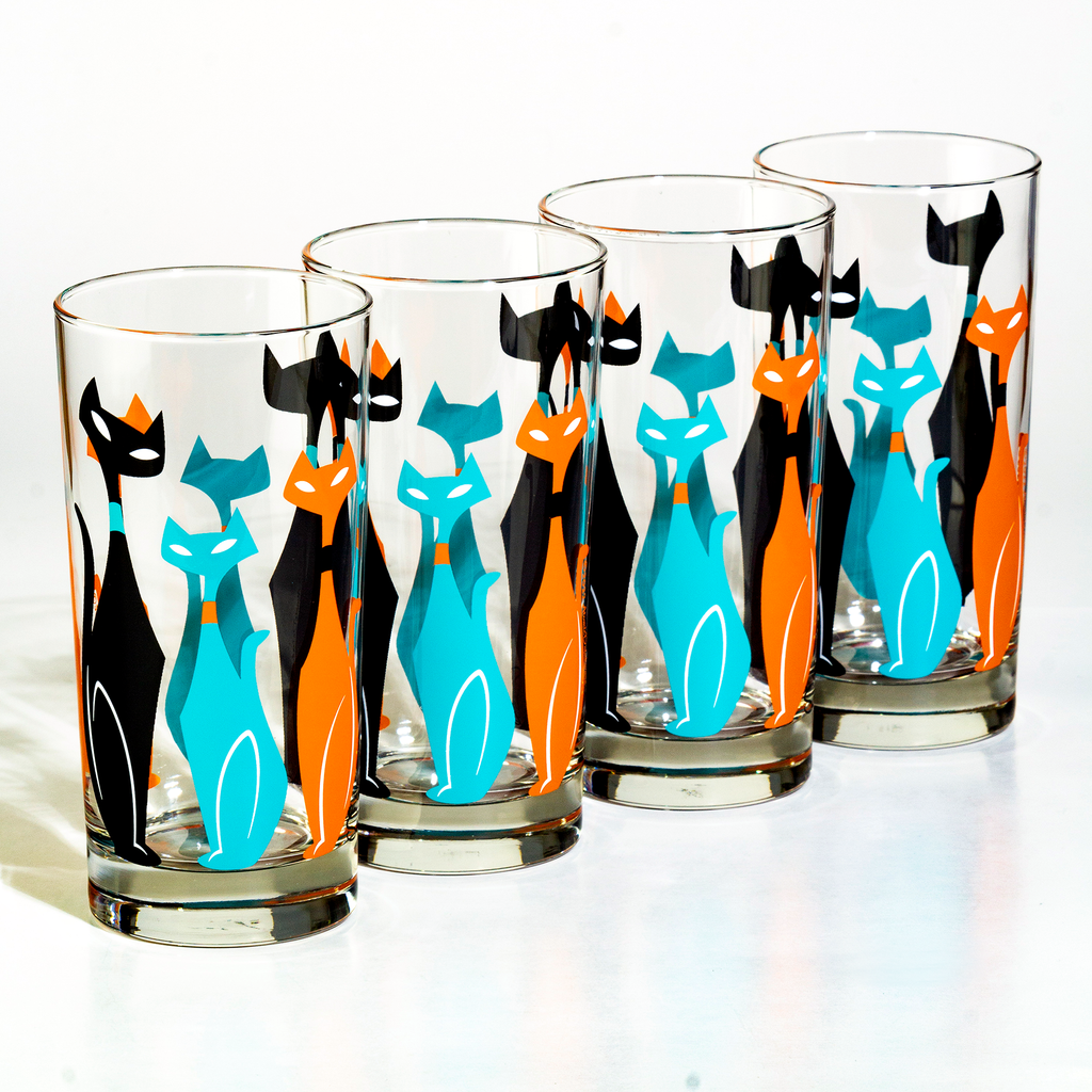 Set of four glass tumblers with colorful mid century cat design on a white background