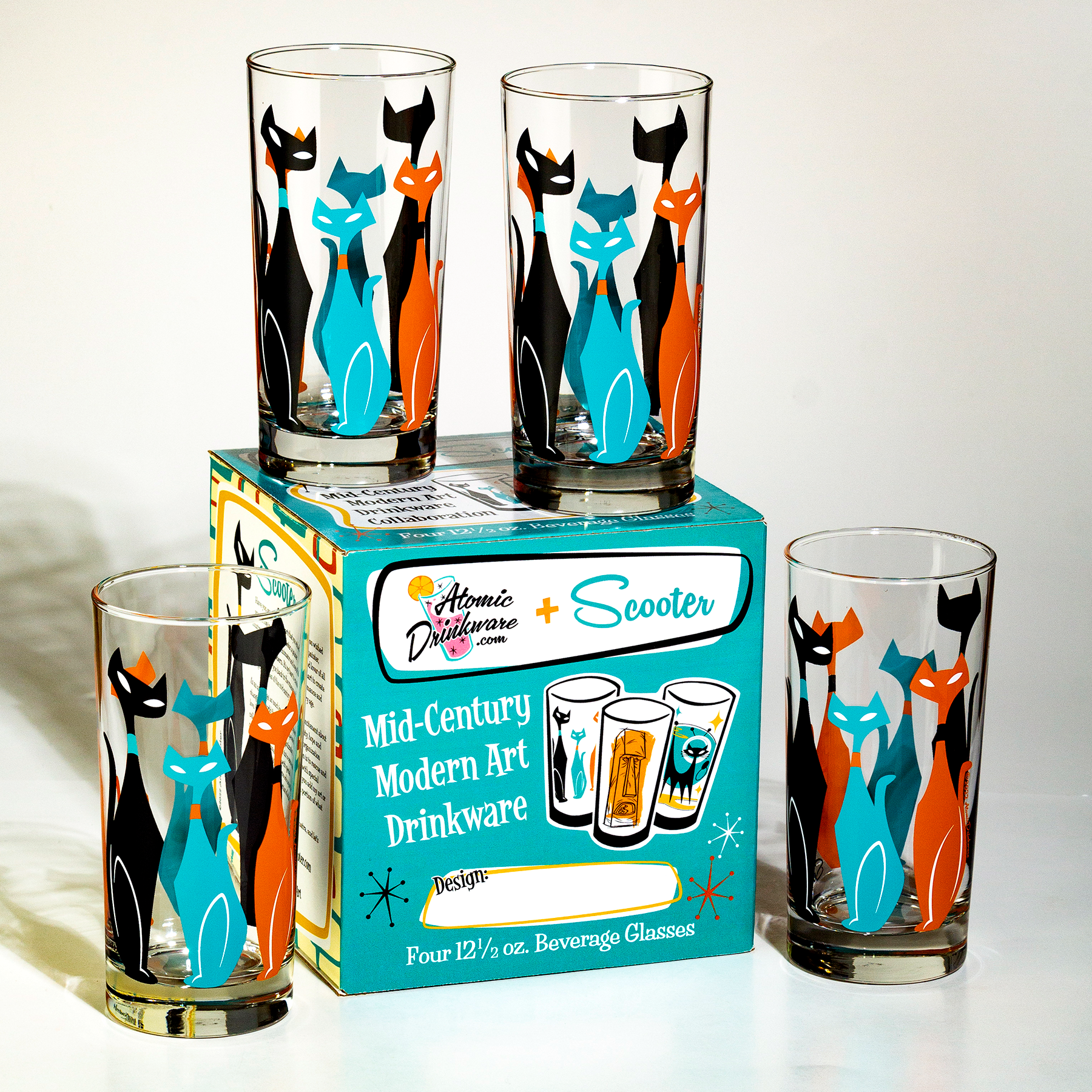 Set of four vintage-style cat-themed glasses with a atomic drinkware box on a white background
