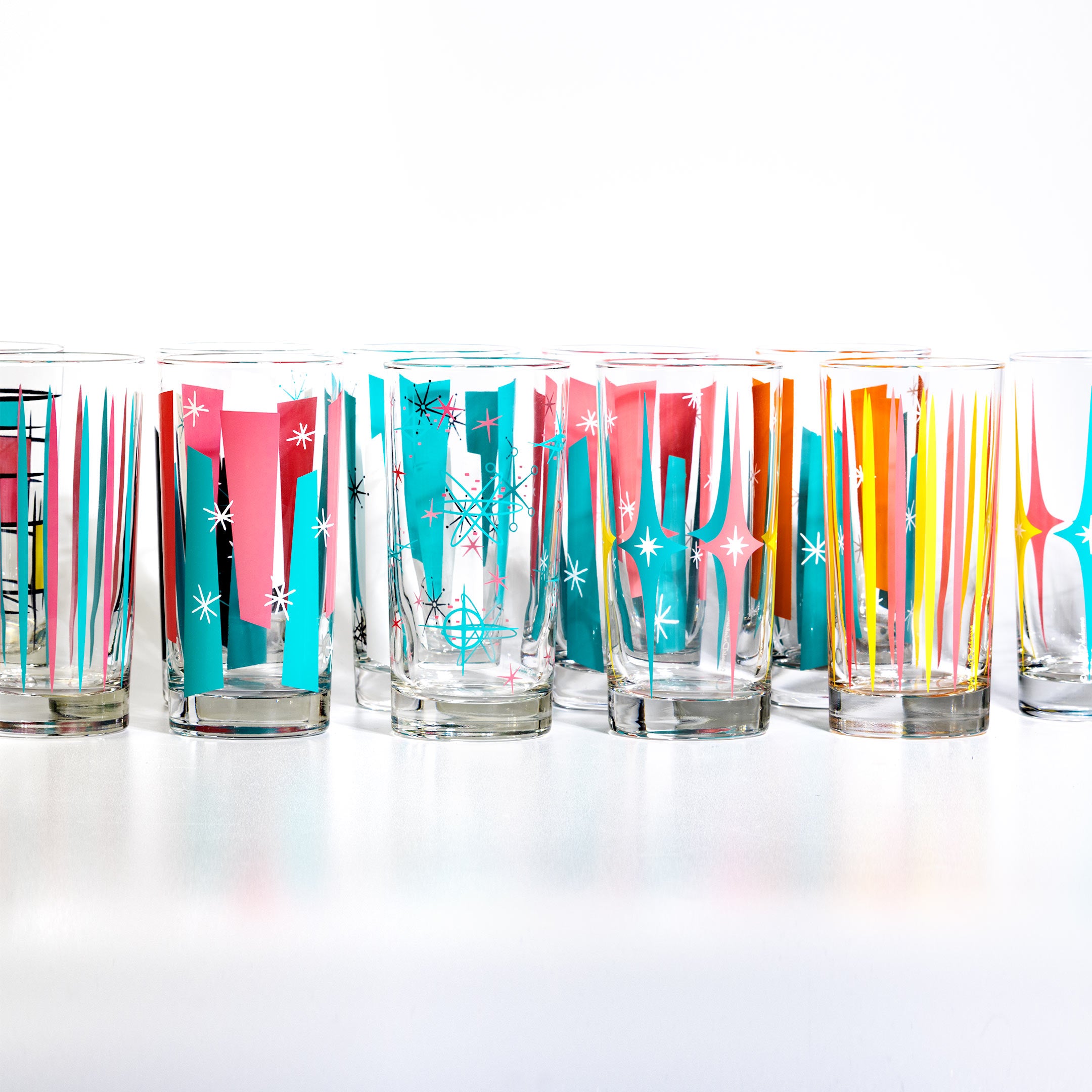 Set of colorful tumblers with abstract designs on a white background