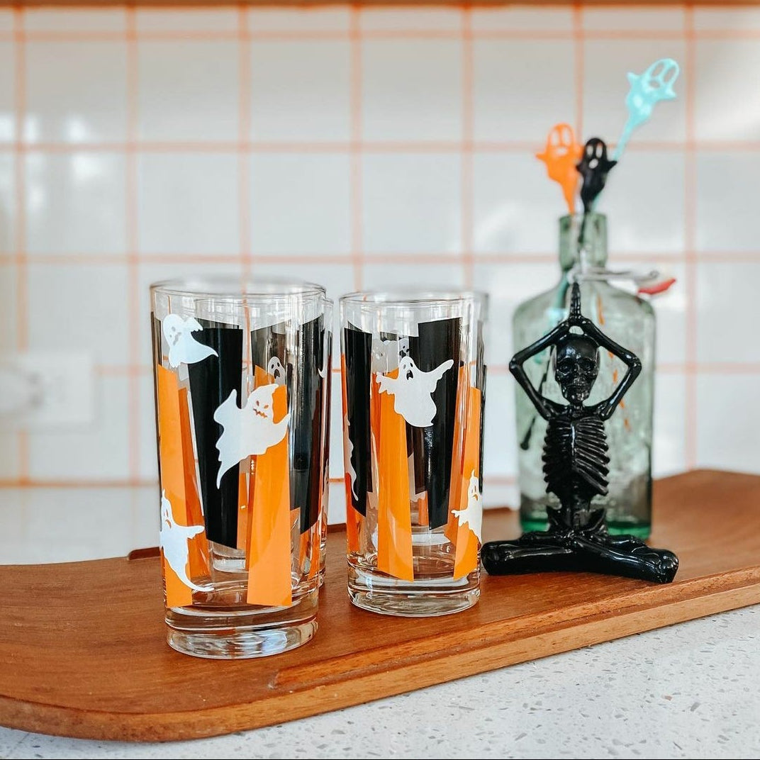 Glowing Ghouls Collins glass on a counter with spooky background