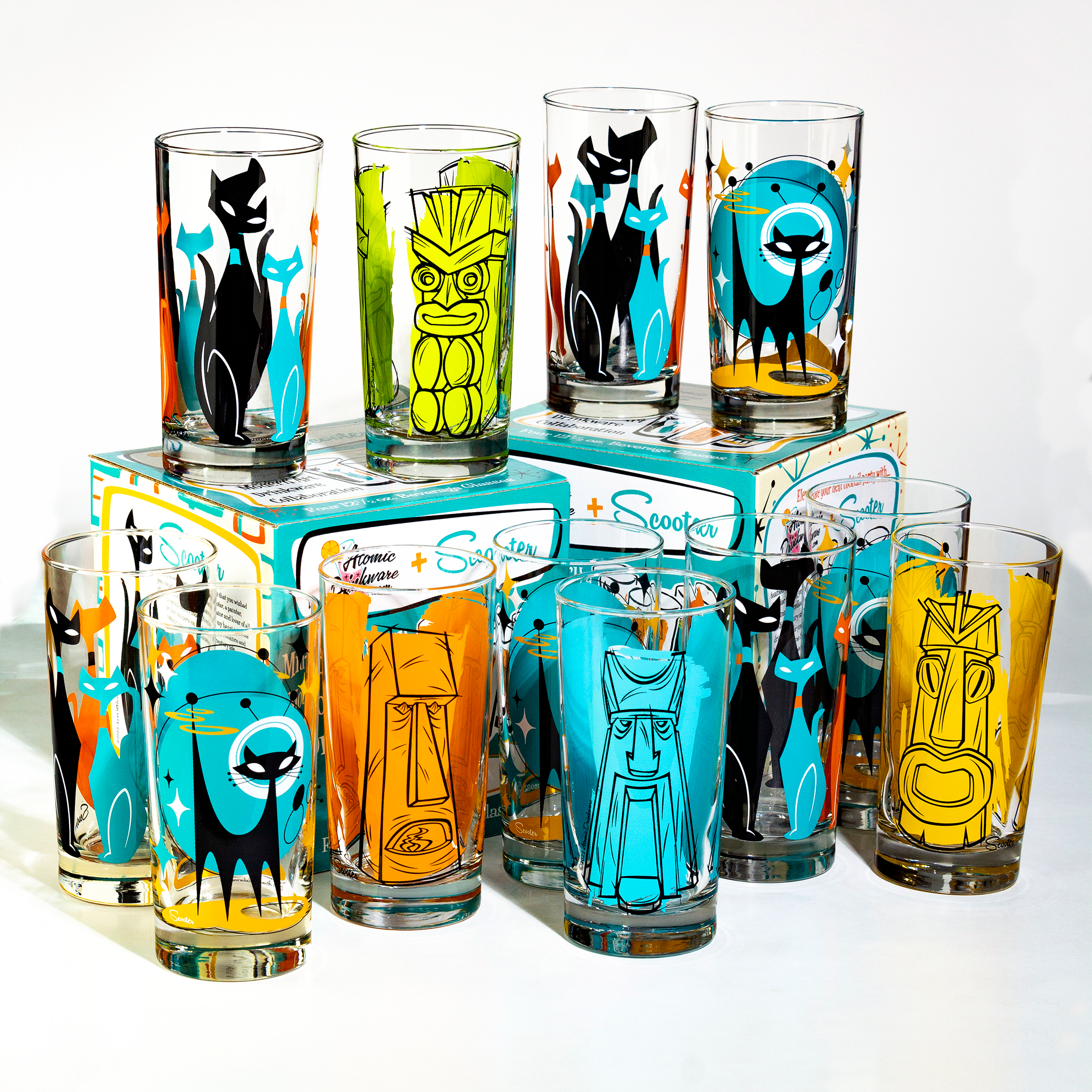 Set of colorful retro cocktail glasses for cat lovers and tiki tumblers with mid century cat designs on a white background.