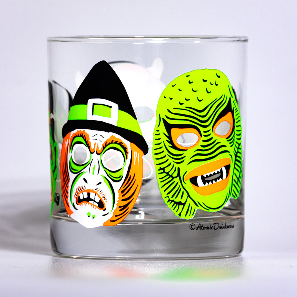 Halloween drinkware featuring retro mask designs that glow under blacklight. 