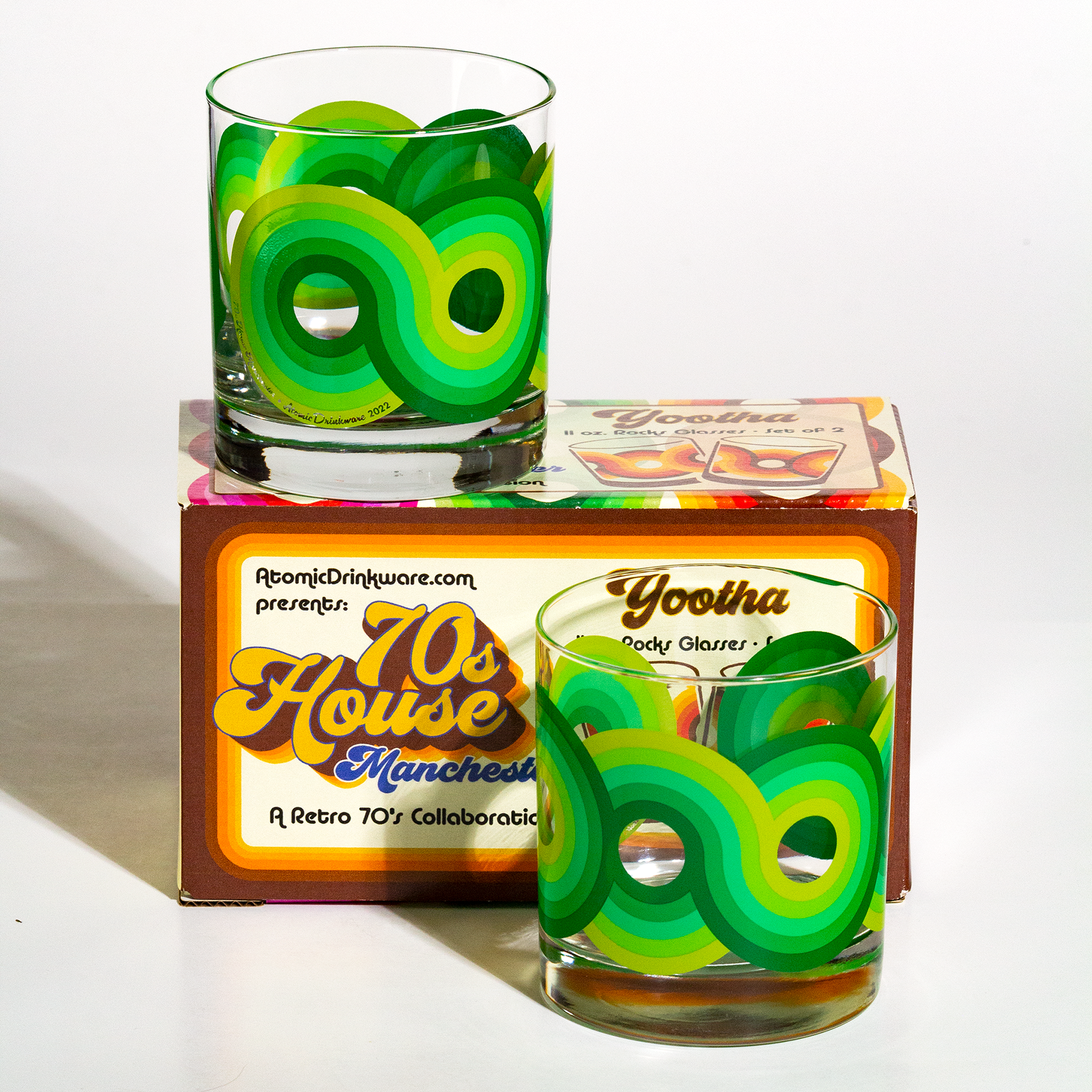Two retro-style glass tumblers with lime green and yellow design on a white background, featuring '70s House Manchester' packaging.