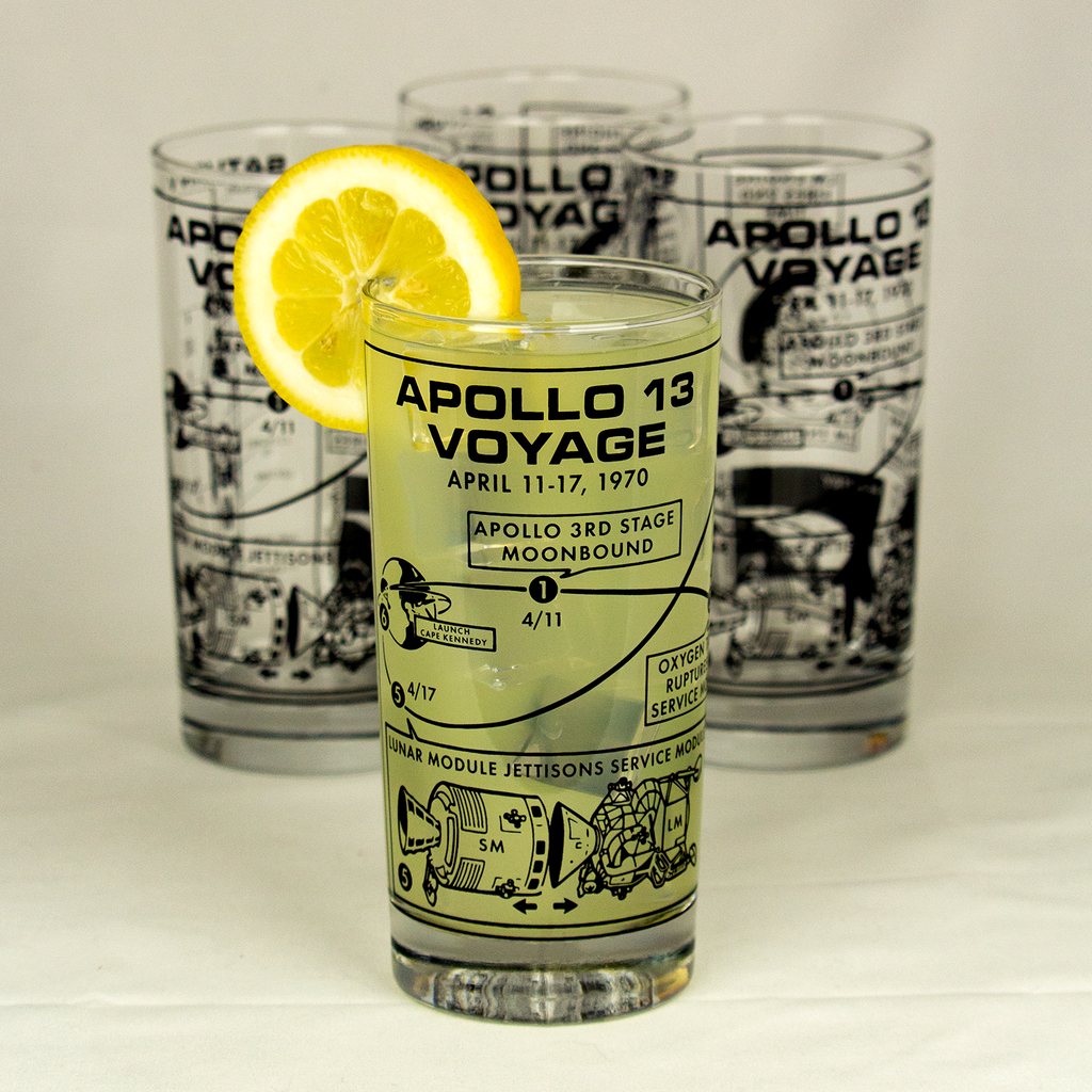 Glass with 'Apollo 13 Voyage' design featuring a lemon slice, on a light background.