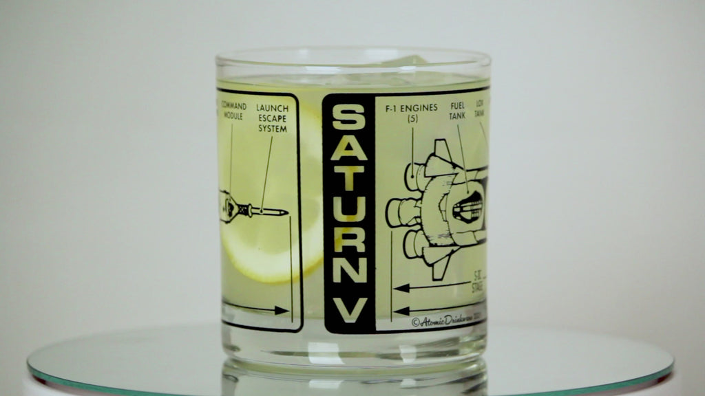 Clear glass with black and white graphic design of Saturn V rocket on a white background